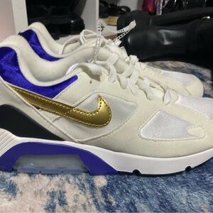Nike White Sneakers with Purple Trim and Gold Swoosh